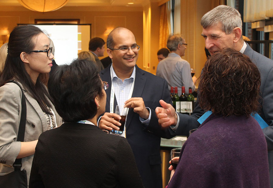 A group of five Forum attendees speaking in a circle