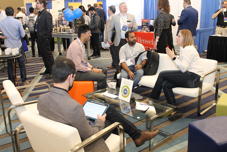 Conference attendees enjoying a networking lounge