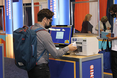 an-attendee-picks-his-badge-from-the-printer