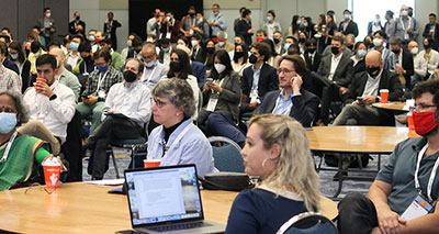 previous_attendees_at_tables_and_watching_a_presentation